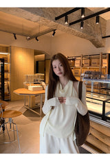 Flower brooch striped long-sleeved knit shirt