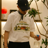 DAKYAM 2025S/S ポスタルジャーニープリンティングTシャツ