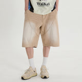 Cutting washed denim bermuda pants