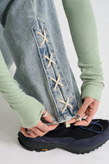 Sage cross lace denim pants