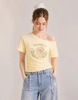 ダイアサマーヴィンテージグラフィックシャーリングワンショルダーTシャツ バター