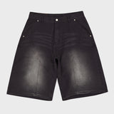 Cutting washed denim bermuda pants