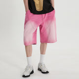 Cutting washed denim bermuda pants