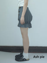 Smocked mini skirt with adjustable buckle