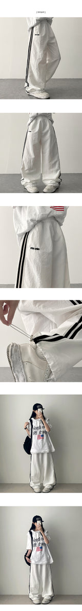 Dev Lettering Embroidered トラックツーラインワイドパンツ
