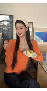 オレンジディープVネックツウィステッドロングスリーブニットウェア
