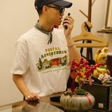 DAKYAM 2025S/S ポスタルジャーニープリンティングTシャツ