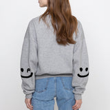 エルボードローイングスマイルクロップドスウェットシャツ / ELBOW Drawing Smile Cropped Sweatshirt