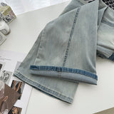 Belted light blue bootcut denim pants