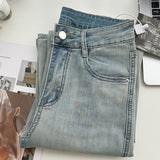 Belted light blue bootcut denim pants
